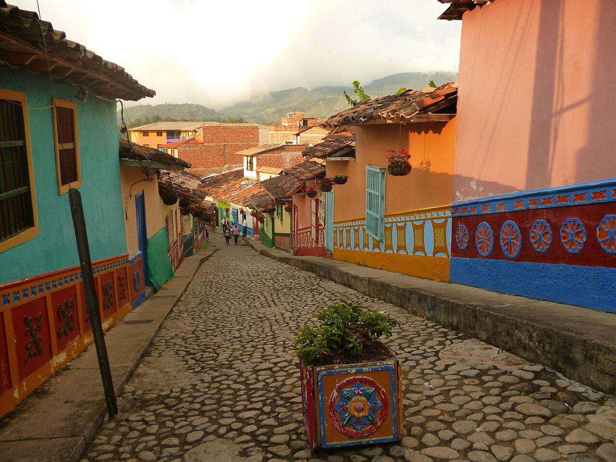A cobblestone street in Guatapé lined with brightly painted houses