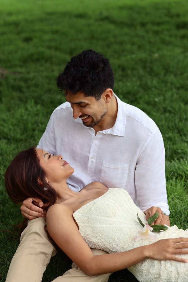 Trinique resting in Juan Pablo's arms on the grass